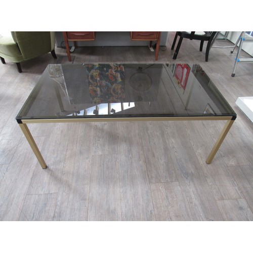 9335 - A Danish rectangular brassed square metal framed coffee table with smoked glass top. 120cm x 65cm x ... 