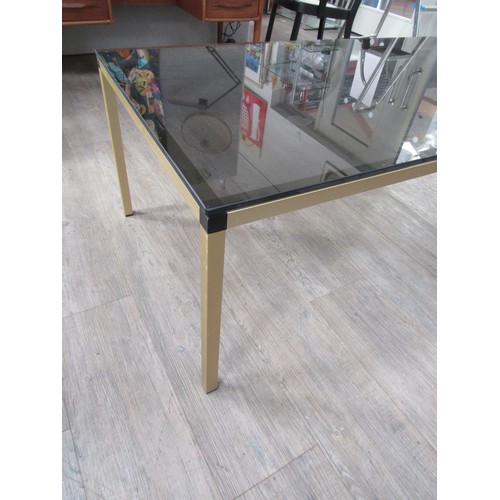 9335 - A Danish rectangular brassed square metal framed coffee table with smoked glass top. 120cm x 65cm x ... 