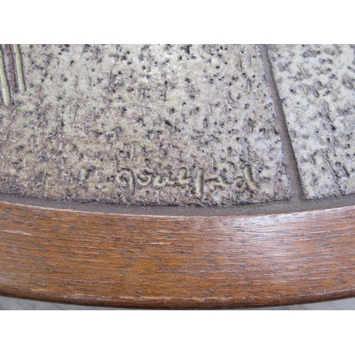 9365 - A Danish circular coffee table with stoneware tiled top and dark stained wooden frame. 108cm diamete... 