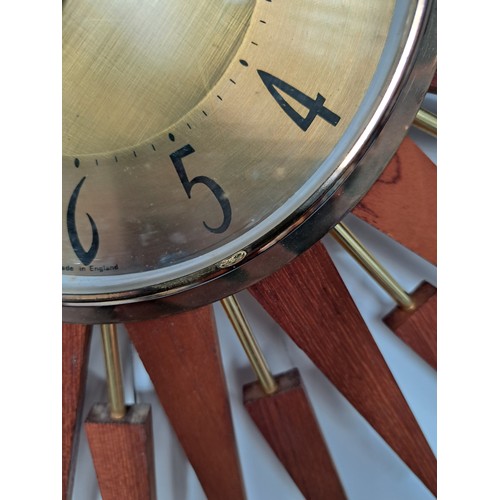 9248 - A Starburst wall clock by Ansley & Wilson with teak and brassed finish, 63.5cm diameter