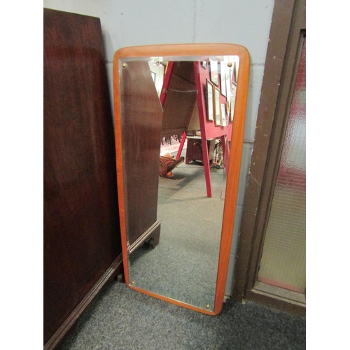 1020 - A retro teak wall mirror with bevelled glass, 98cm x 44cm total