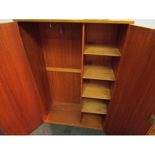 1041 - A teak two door gentleman's wardrobe, with key, 132cm high x 89cm wide x 41cm deep   (R) £20 Blyth B... 