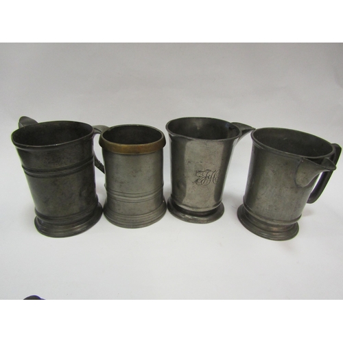 1297 - A group of pewter tankards and measures, Georgian and later, some with inscribed details to base (6)... 