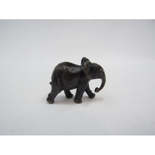 1374 - A miniature solid bronze elephant. 4cm long   (C)