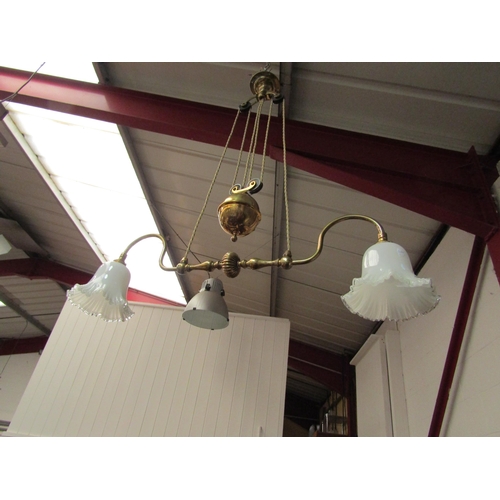 1554 - A heavy brass rise and fall ceiling light with milky white Victorian glass lamp shades with a frill ... 