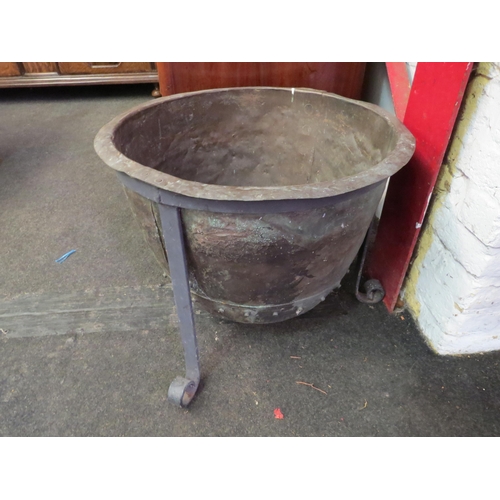 1001 - A rivetted copper copper on tripod footed stand, 43cm high x 52cm diameter