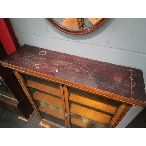 1102 - An oak bookcase with glazed doors and shelved interior on a later pine base, 127cm high x 98cm wide ... 