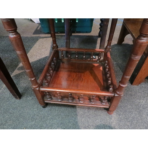 1113 - An Edwardian walnut occasional table with canted corner top over turned supports and spindle gallery... 