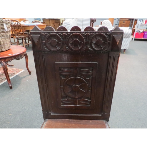 1114 - An oak hall chair with heavily carved back and bobbin turned front legs