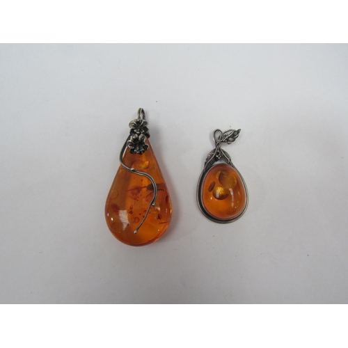 1338 - An amber bead necklace and two amber pendants in  the art nouveau style