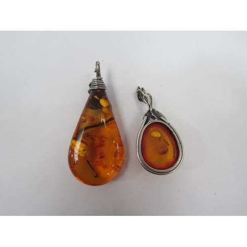 1338 - An amber bead necklace and two amber pendants in  the art nouveau style