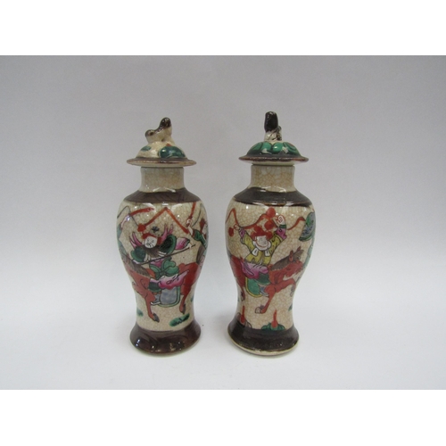 1388 - An Oriental Satsuma style vase depicting soldiers on horseback with cover and a similar pair of jars... 