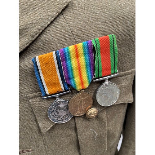 9001 - A WWI officer's jacket and peaked cap together with medals, holster, Sam Browne belt with frog and e... 