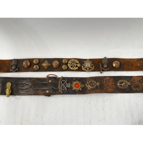 9078 - Two Sam Browne leather belts together with two further belts with applied military badges including ... 