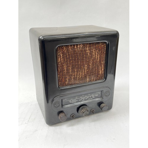 9082 - A Third Reich era German VE301 radio, Bakelite case with textile speaker cover, two Nazi Swastika ro... 