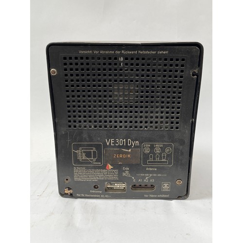 9082 - A Third Reich era German VE301 radio, Bakelite case with textile speaker cover, two Nazi Swastika ro... 