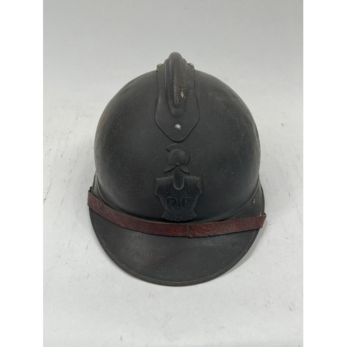 9126 - A WWI French Adrian helmet to the artillery with most of its original paint finish, no lining or chi... 