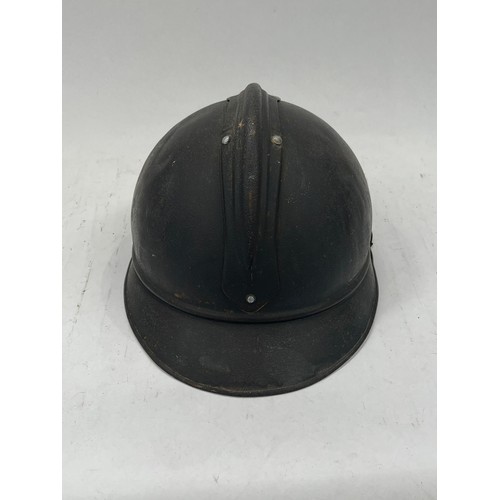 9126 - A WWI French Adrian helmet to the artillery with most of its original paint finish, no lining or chi... 