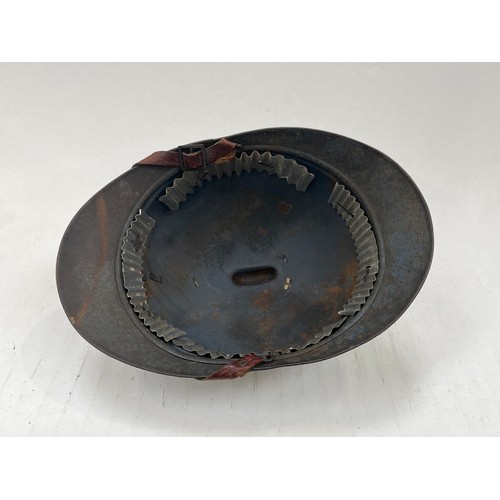 9126 - A WWI French Adrian helmet to the artillery with most of its original paint finish, no lining or chi... 