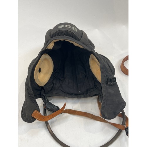 9133 - A brown leather pistol holster, a post-war set of goggles and a 1950’s tank crew helmet (3)