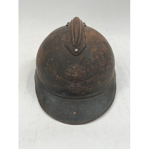 9134 - A WWI French Adrian helmet to the artillery with most of its original paint finish, no lining or chi... 