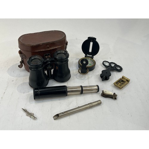 9153 - A pair of wartime binoculars, a field compass, multi-lens magnifying glass, silk cigarette cards and... 