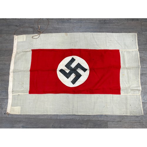 9161 - A Third Reich era German flag, the black swastika within a white roundel, upon a red rectangle, deep... 