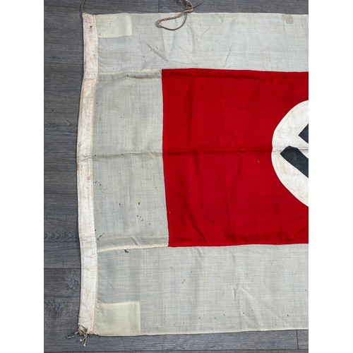 9161 - A Third Reich era German flag, the black swastika within a white roundel, upon a red rectangle, deep... 