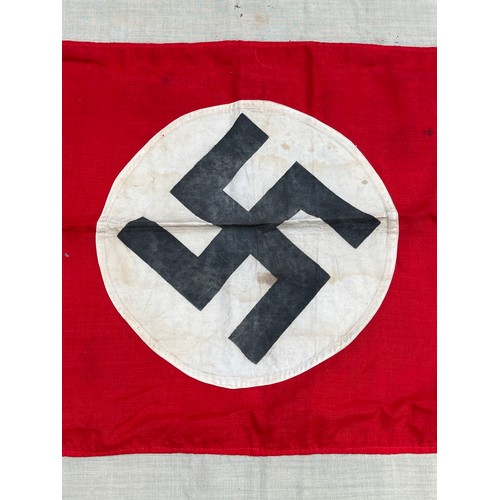 9161 - A Third Reich era German flag, the black swastika within a white roundel, upon a red rectangle, deep... 