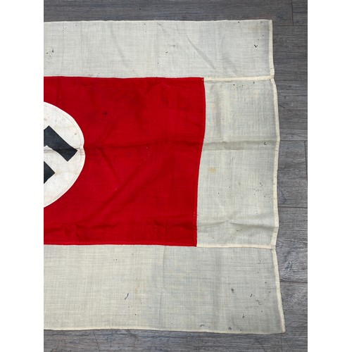 9161 - A Third Reich era German flag, the black swastika within a white roundel, upon a red rectangle, deep... 