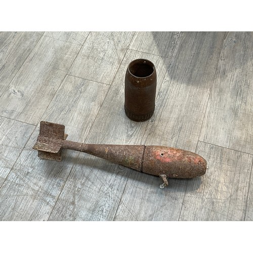 9174 - A Mk. 3 25lb practice bomb in relic condition together with a shell section (2)