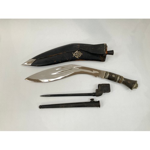 9180 - A 20th Century Indian kukri with 5th Gurkha badge, together with a British No. 4 spike bayonet with ... 