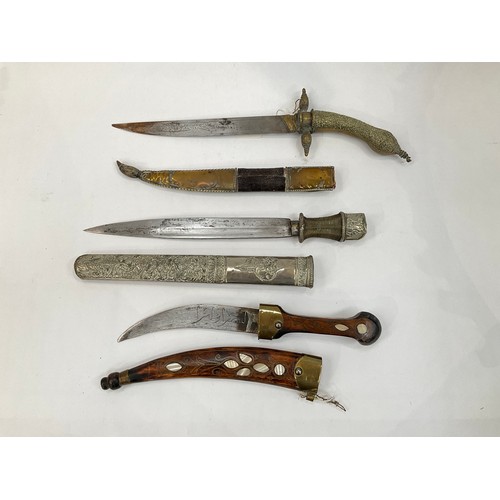 9181 - Three various decorative middle eastern daggers including Persian