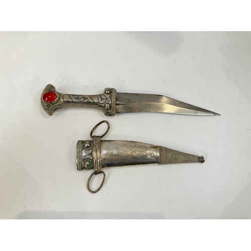 9184 - A North African jambiya style dagger, white metal covered with inset gemstone, reputedly brought bac... 