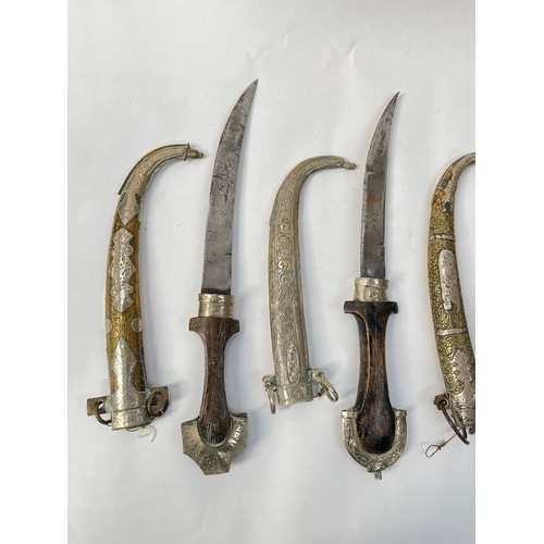 9186 - Four various decorative koumya daggers, brass and white metal scabbards