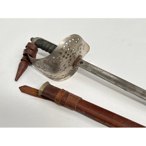 9207 - A British 1897 pattern officer’s sword with George VI cypher, acid etched blade, battledress scabbar... 