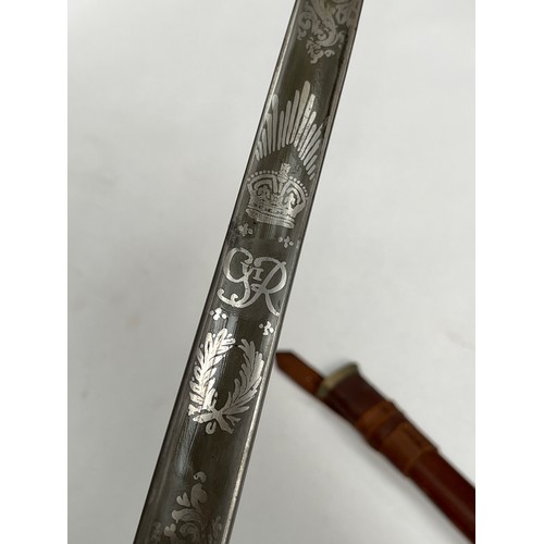 9207 - A British 1897 pattern officer’s sword with George VI cypher, acid etched blade, battledress scabbar... 