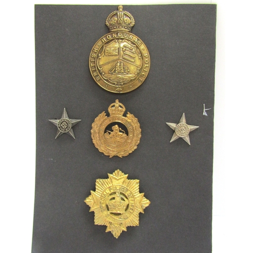 9429 - A colonial British Honduras Police helmet badge, King's crown, together with British South Africa Po... 