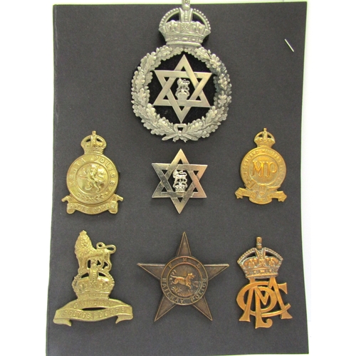 9430 - A collection of colonial police badges including Trinidad helmet and cap badges, Kenya Police, Malay... 