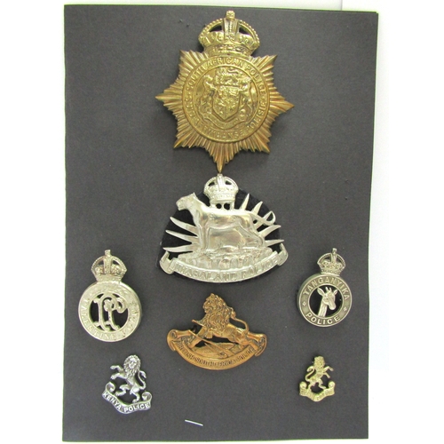 9431 - A collection of colonial police badges including South African Police helmet badge with King's crown... 