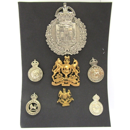 9432 - A collection of colonial police badges including Jamaica Constabulary helmet plate, King's crown, no... 