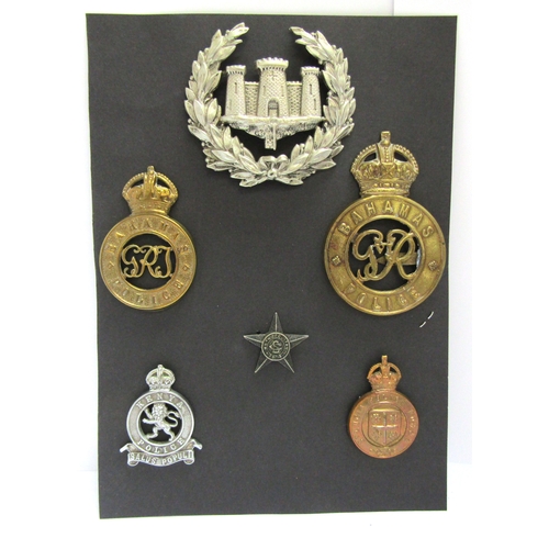 9433 - A collection of colonial police badges including Gibraltar helmet badge, Bahamas  helmet and cap bad... 