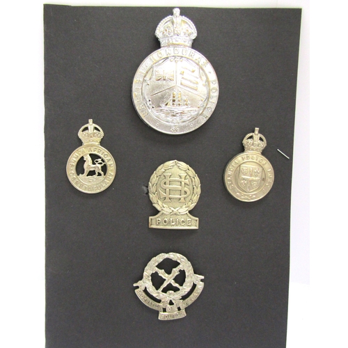 9434 - Five colonial police badges including Honduras helmet badge, and cap badges for South Africa Constab... 