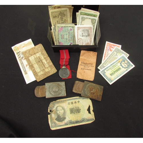 9452 - A cash tin containing a German Eastern Front Medal 1941/42 and two WWI German belt buckles (both cor... 