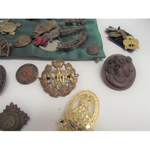 9492 - A quantity of military insignia including shoulder titles and cap badges including RAF and Red Cross