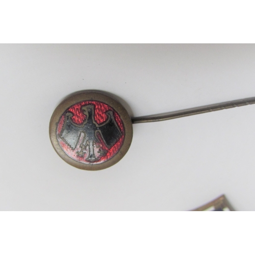 9477 - A gold stick pin tin of swastika form set with seed pearls, together with an interwar era Reichsbann... 