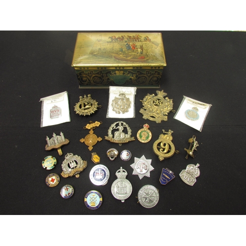 9449 - A quantity of British insignia including WWI era Norfolk and Suffolk Regiment cap badges, silver ARP... 