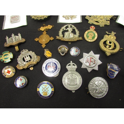 9449 - A quantity of British insignia including WWI era Norfolk and Suffolk Regiment cap badges, silver ARP... 