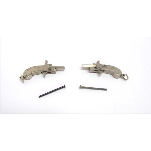 9450 - A pair of obsolete calibre Austrian 2mm pinfire miniature pistols, scrolled foliate design grips. OB... 