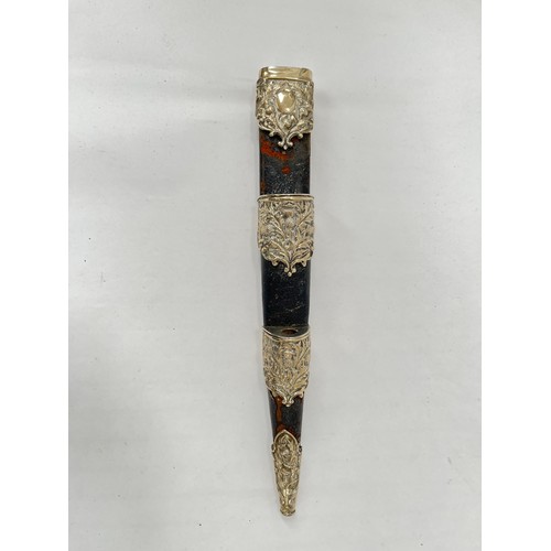 9222 - A piper's dirk by Lawrie of Glasgow, carved basket-weave handle, the pommel with artificial gemstone... 